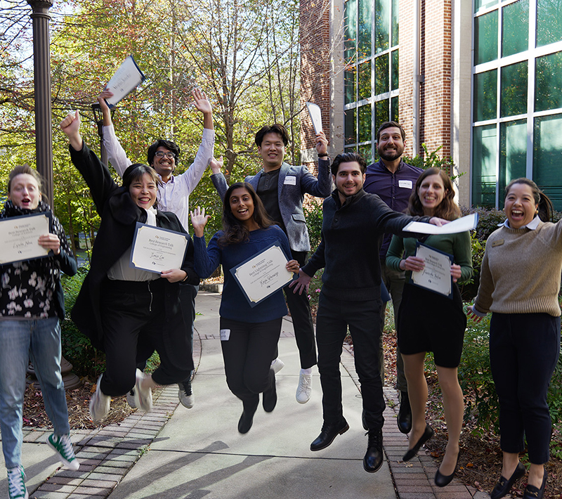Group of graduate students jumping for joy