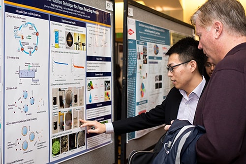Graduate student presenting research at CRIDC poster competition