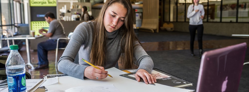 Student writing on piece of paper