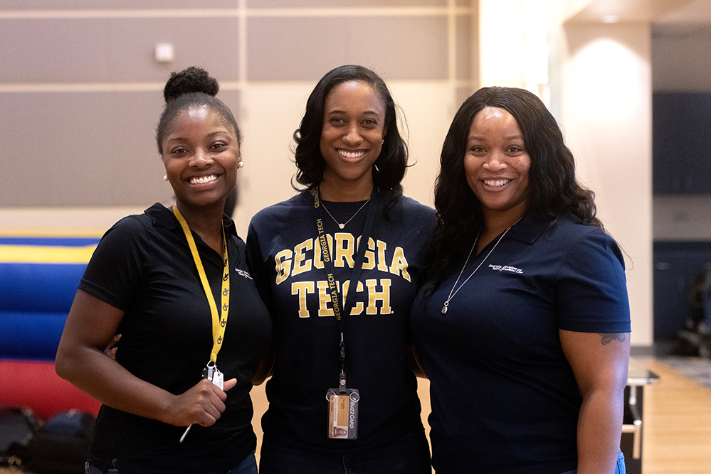 Three students smiling at camera