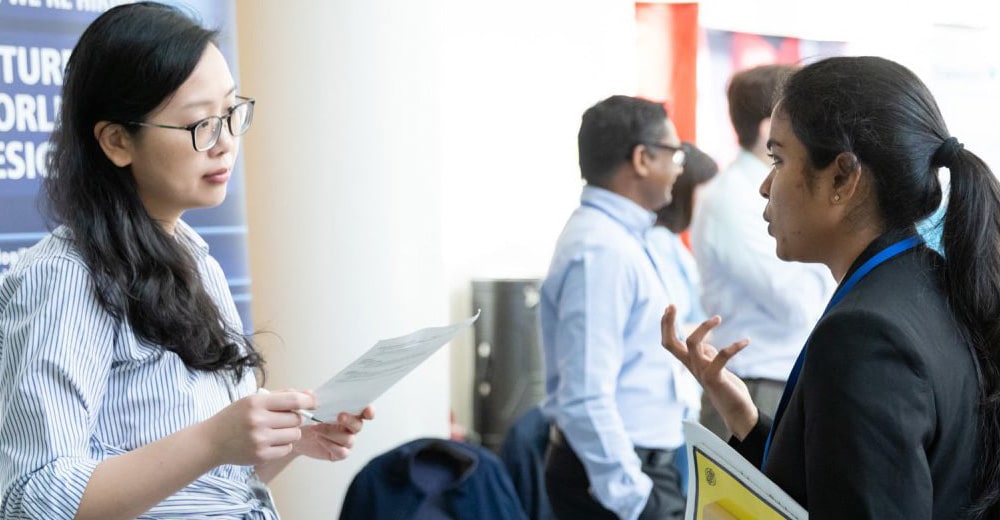 Student talking to recruiter at career fair