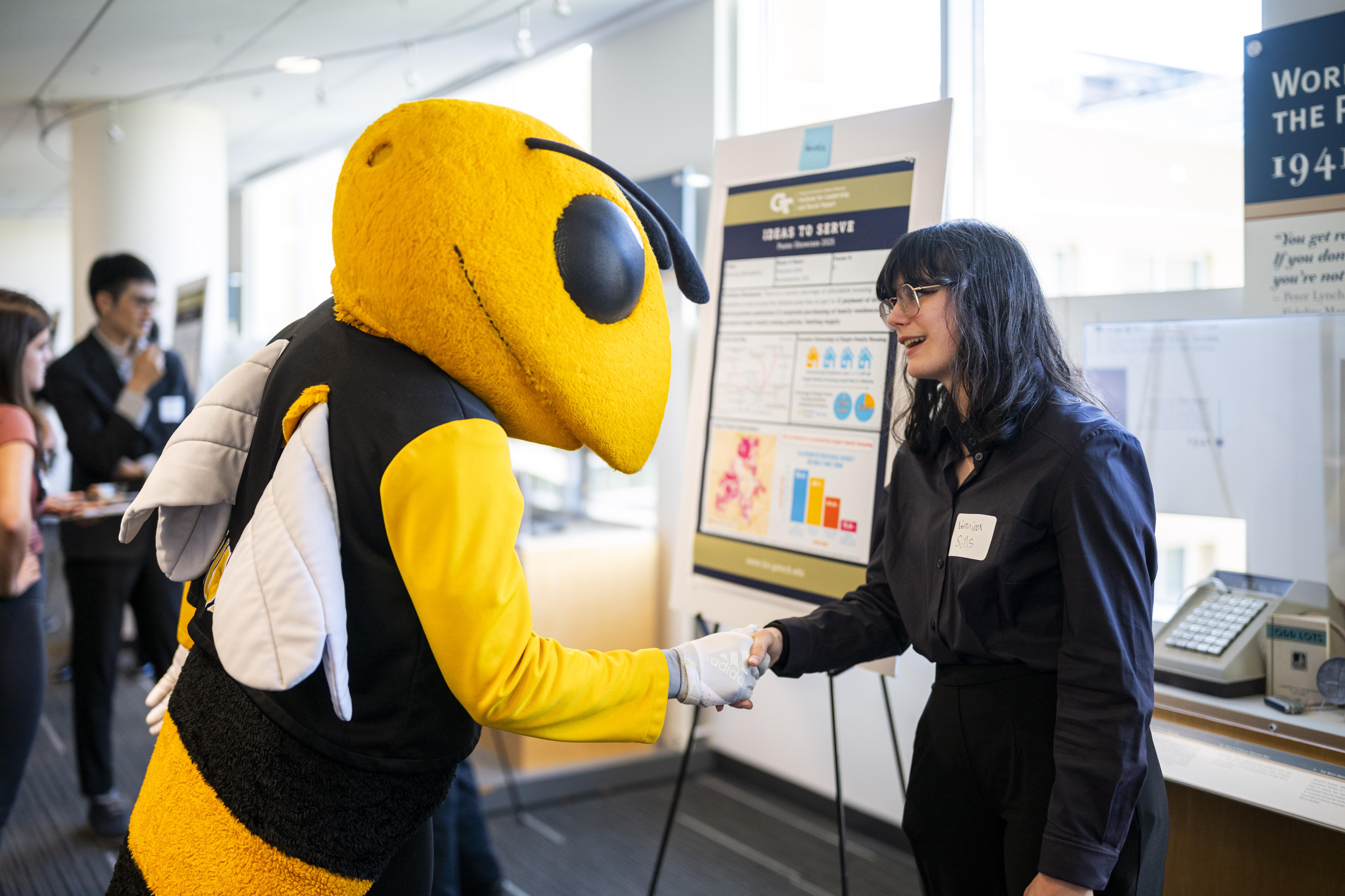 Ideas to Serve Showcase photo (participant and Buzz)