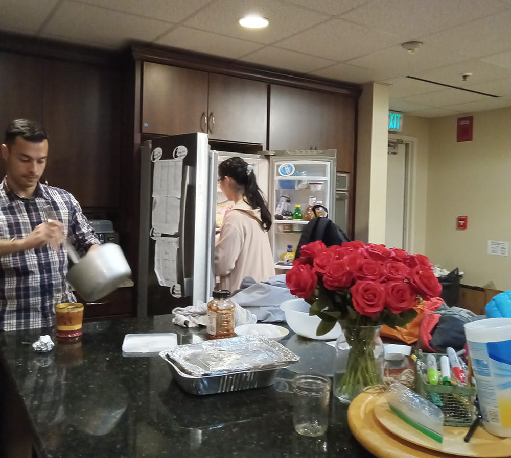 Grad students making breakfast in kitchen